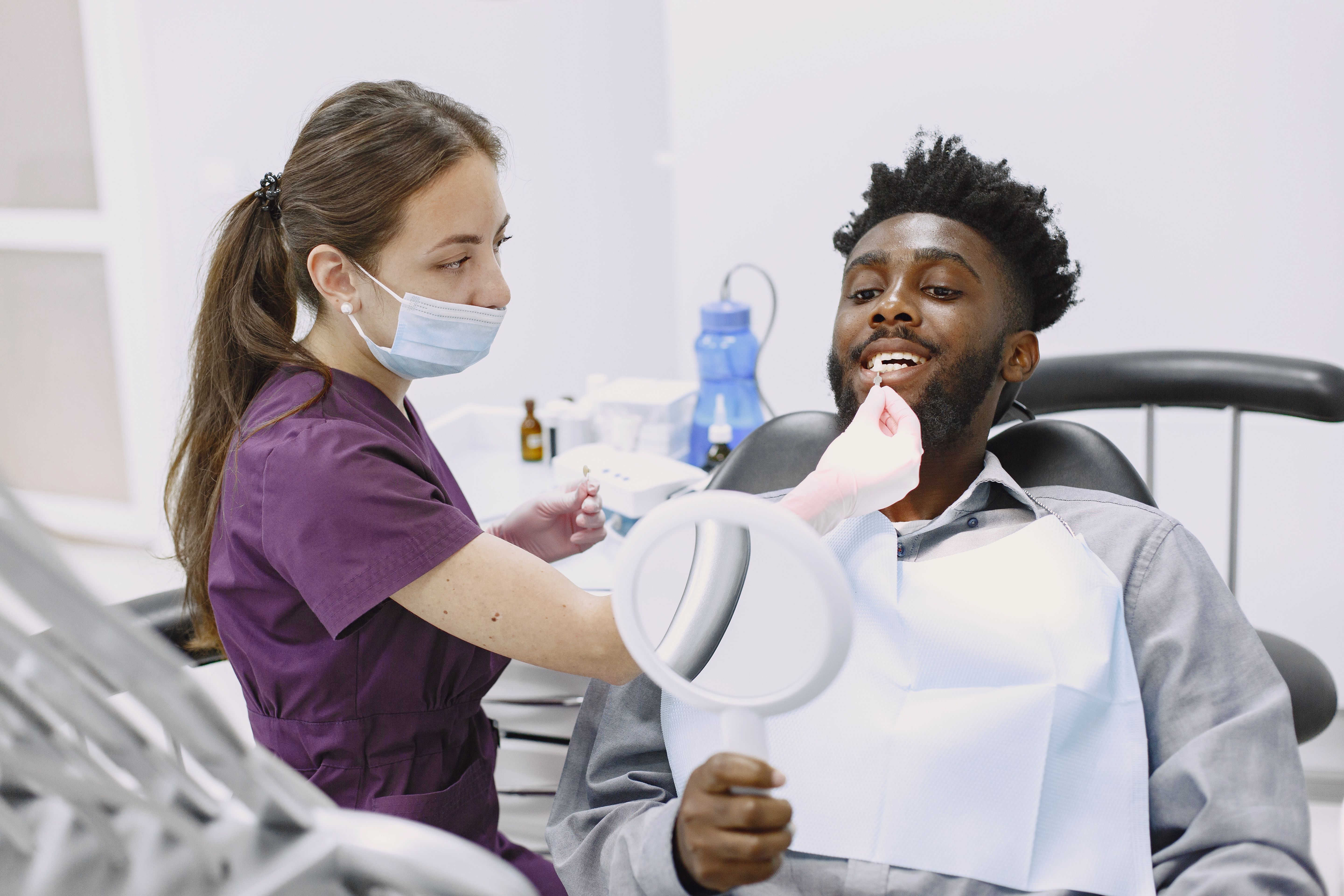 Dentist performing a check-up on a patient in a modern dental office.