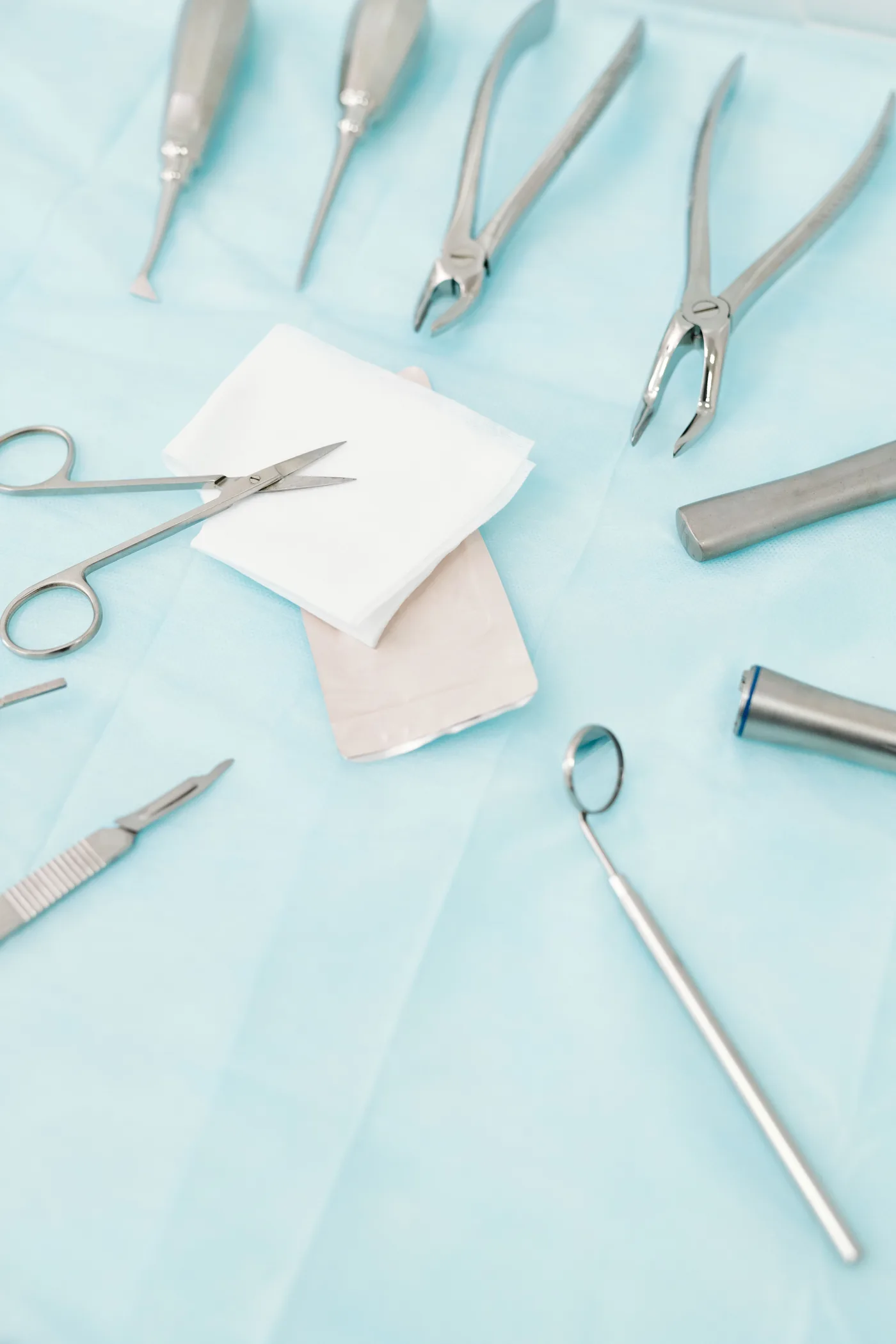 Sterile dental surgical instruments arranged for oral surgery care.