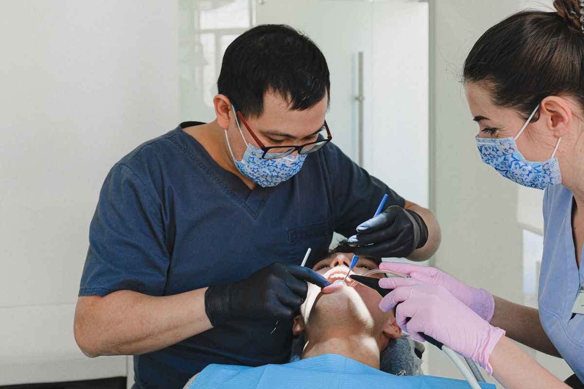 Dental professionals checking a patient in a clinic.