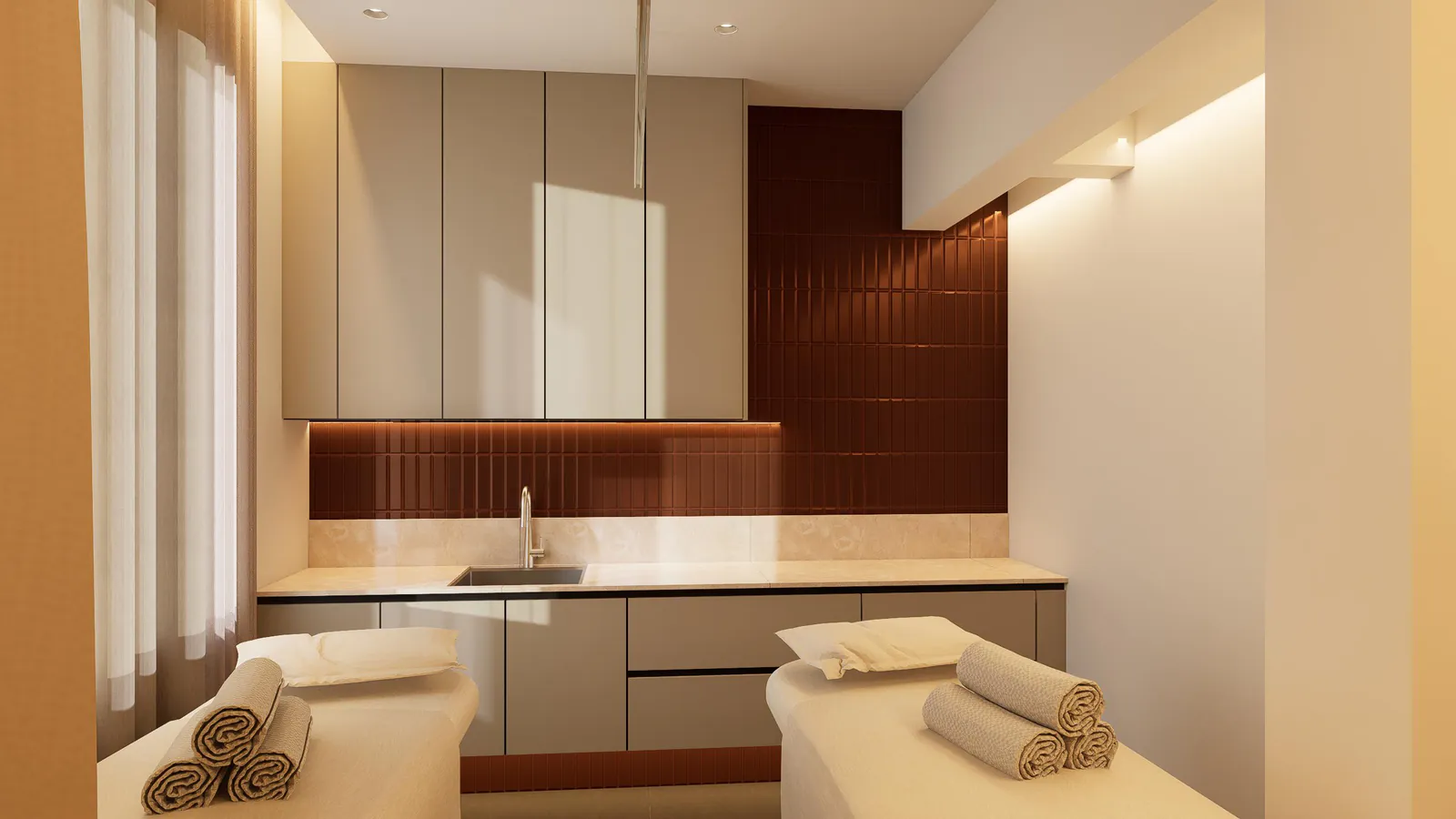 Shared treatment room angle showing both beds and integrated clinical sink area.