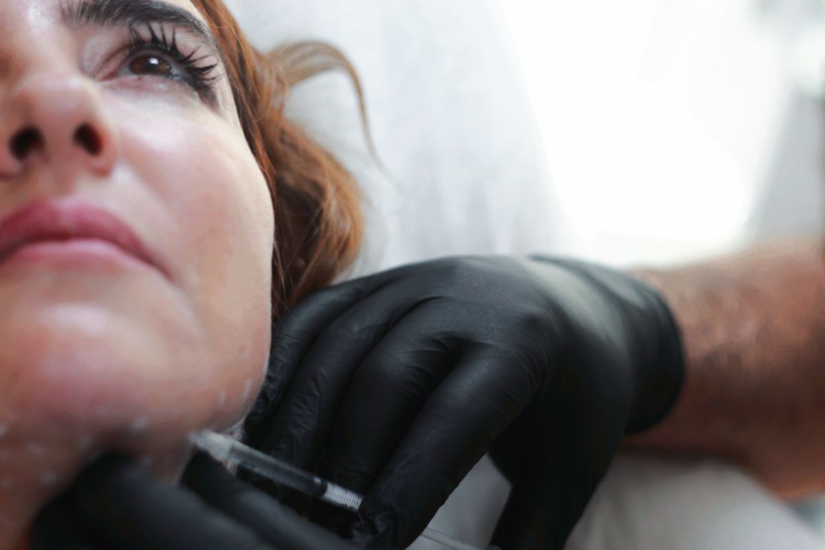 Doctor-led injectable treatment preparation in a clinical setting.