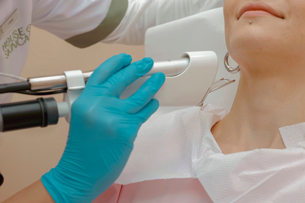 Controlled facial laser treatment in a clinic room.